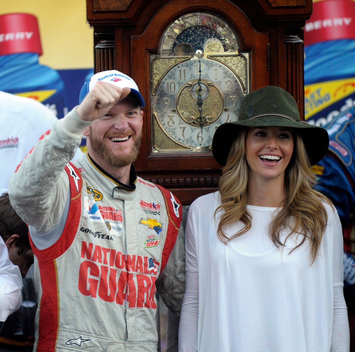 Dale Earnhardt Jr., left, and his girlfriend Amy Reimann, right, celebrate after he won the NASCAR Sprint Cup Series auto race at Martinsville Speedway in Martinsville, Va., Sunday, Oct. 26, 2014. The grandfather clock, background, is the winner's trophy. (AP Photo/Don Petersen) (AP)