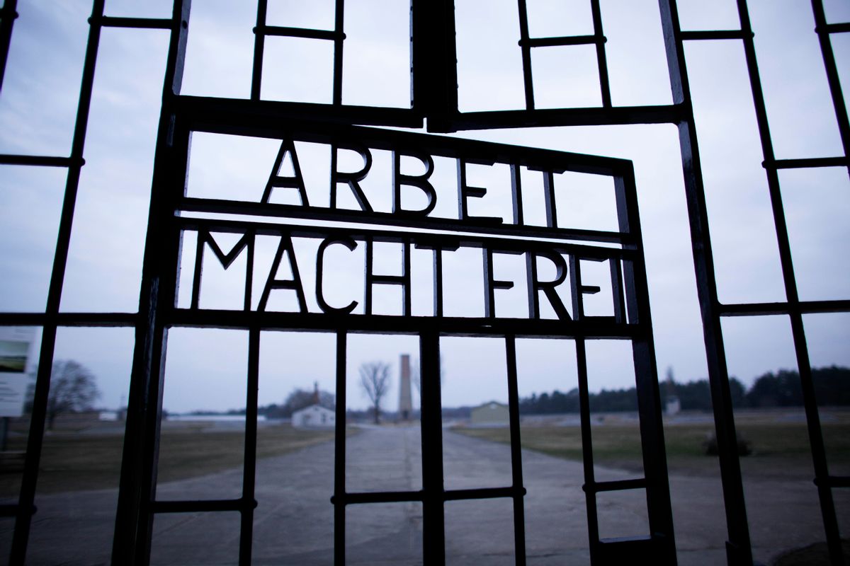 FILE - This Jan. 27, 2012, file photo shows the words 'Arbeit Macht Frei' (Work Sets You Free) at the main entrance of the Sachsenhausen Nazi concentration camp on the international Holocaust remembrance day in Oranienburg, Germany. An Associated Press investigation found dozens of suspected Nazi war criminals and SS guards collected millions of dollars in Social Security payments after being forced out of the United States.  (AP/Markus Schreiber)