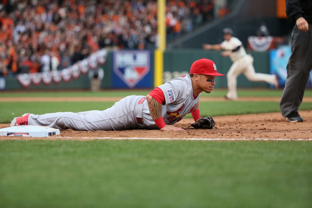 St. Louis Cardinals second baseman Kolten Wong lies by first base after he was unable to reach a wide throw by pitcher Randy Choate that allowed the game-winning San Francisco Giants run to score in the 10th inning of Game 3 of baseball's NL Championship Series, Tuesday, Oct. 14, 2014, in San Francisco. The Giants won 5-4 in 10 innings. (AP Photo/St. Louis Post-Dispatch, Chris Lee) (AP)