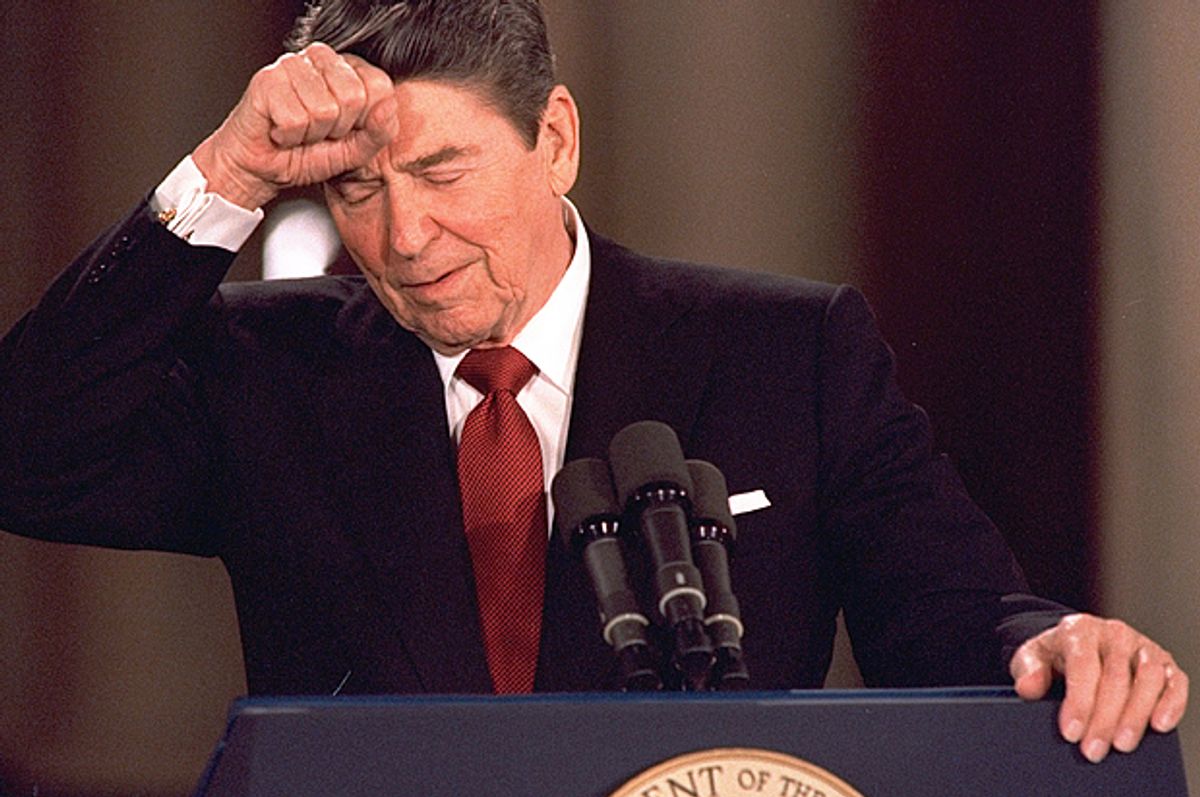 Ronald Reagan knocks his head while responding to a reporter's question at a news conference, March 19, 1987.                     (AP/Dennis Cook)