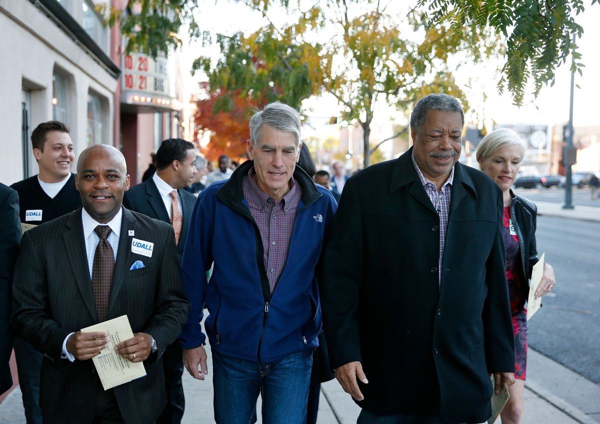 Shortly after mailing his own ballot, U.S. Senator Mark Udall, D-Colo., center, walks with Denver Mayor Michael Hancock, left, former Denver Mayor Wellington Webb, third from left, and President of Planned Parenthood Federation of America Cecile Richards, far right, on a campaign stop to remind voters to mail in their ballots, in the Five Points area of Denver, Monday, Oct. 20, 2014. (AP Photo/Brennan Linsley) (AP)