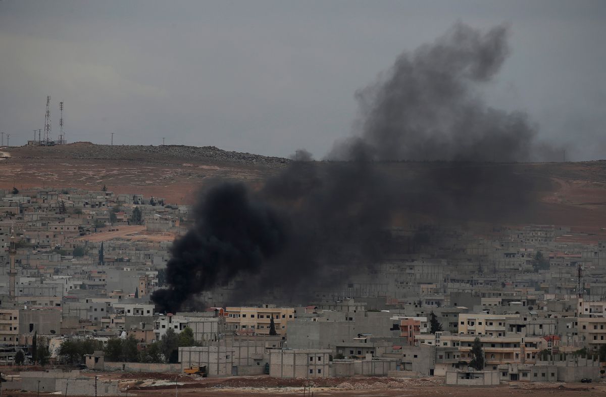 Smoke from a fire rises following a strike in Kobani, Syria, during fighting between Syrian Kurds and the militants of Islamic State group, as seen from a hilltop on the outskirts of Suruc, at the Turkey-Syria border, Sunday, Oct. 19, 2014. Kobani, also known as Ayn Arab, and its surrounding areas, has been under assault by extremists of the Islamic State group since mid-September and is being defended by Kurdish fighters. (AP Photo/Lefteris Pitarakis) (AP)