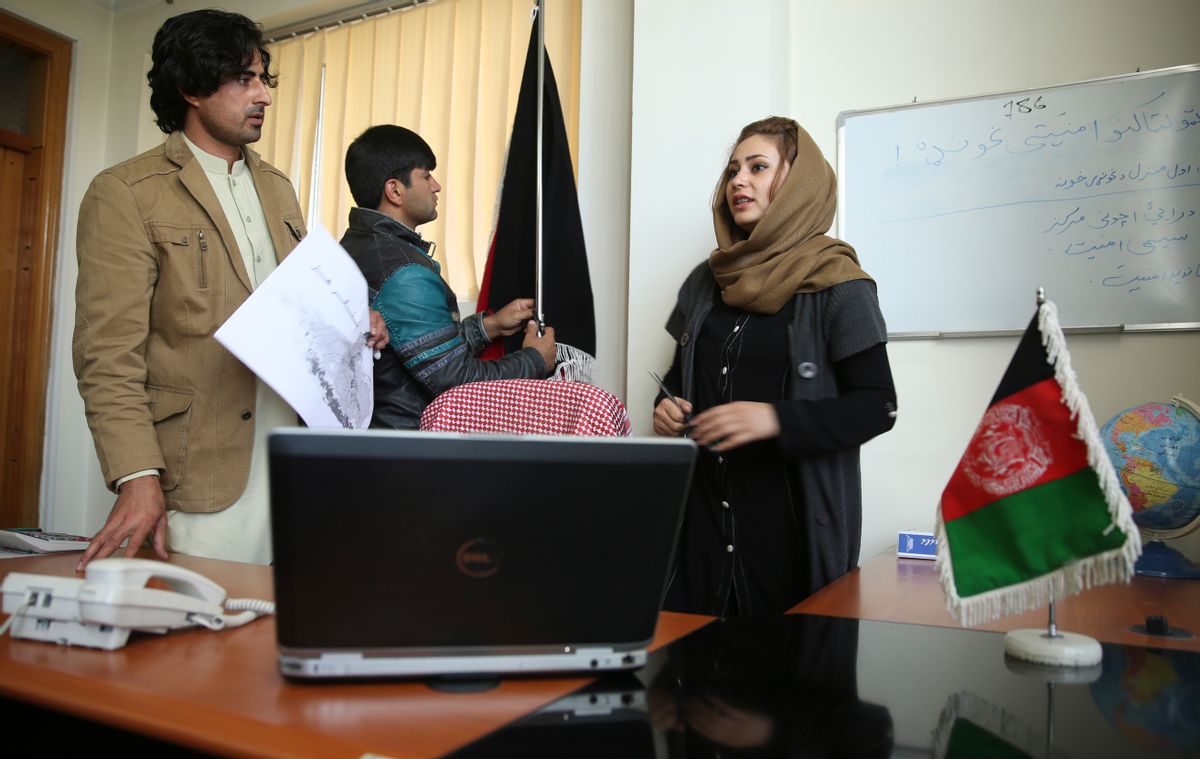 In this photo taken Thursday, Oct. 30, 2014, Afghan art director Roya Haidari, right, talks to her colleagues as they produce "Innocent Heart," a six-part drama, in Kabul, Afghanistan. Independent television networks grew rapidly in Afghanistan after the 2001 U.S.-led invasion that toppled the Taliban. Most TV time, however, is taken up by cheaply produced game shows, talent quests and dubbed soap operas from India and Turkey, as few stations are interested in making expensive dramas that might not attract advertising. (AP Photo/Massoud Hossaini) (AP)