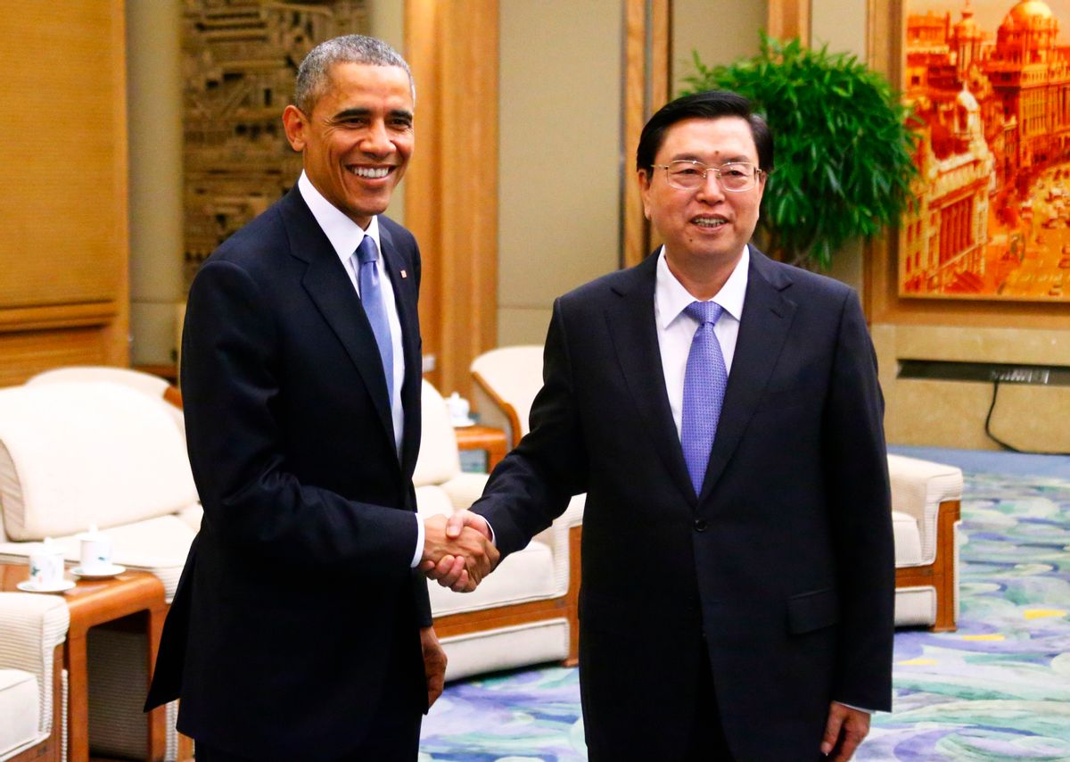 U.S. President Barack Obama (L) shakes hands with Chairman of the Standing Committee of the National People's Congress (NPC) Zhang Dejiang during a meeting at the Great Hall of the People, in Beijing, November 12, 2014. REUTERS/Petar Kujundzic (CHINA)  