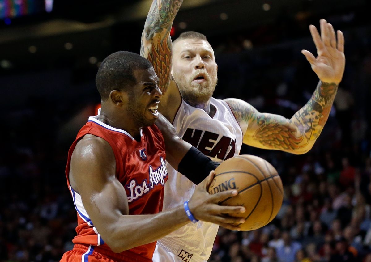 Los Angeles Clippers guard Chris Paul, left, goes up to shoot as Miami Heat forward Chris Andersen, right, defends in the second half of an NBA basketball game, Thursday, Nov. 20, 2014, in Miami. The Clippers defeated the Heat 110-93. (AP Photo/Lynne Sladky) (AP)