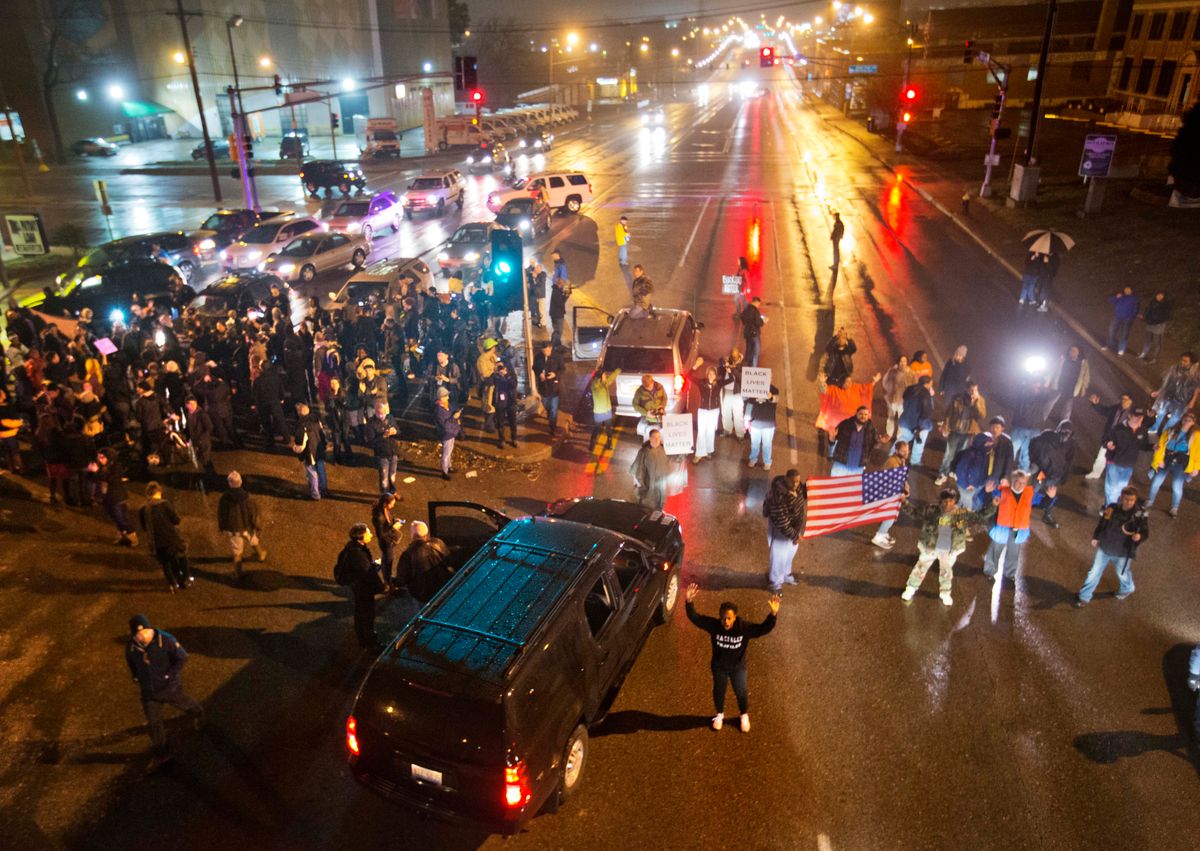 Demonstrators block a busy intersection while marching through the streets to protest the August shooting of Michael Brown, Sunday, Nov. 23, 2014, in St. Louis. Ferguson and the St. Louis region are on edge in anticipation of the announcement by a grand jury whether to criminally charge officer Darren Wilson in the killing of 18-year-old Brown. (AP Photo/David Goldman) (AP)