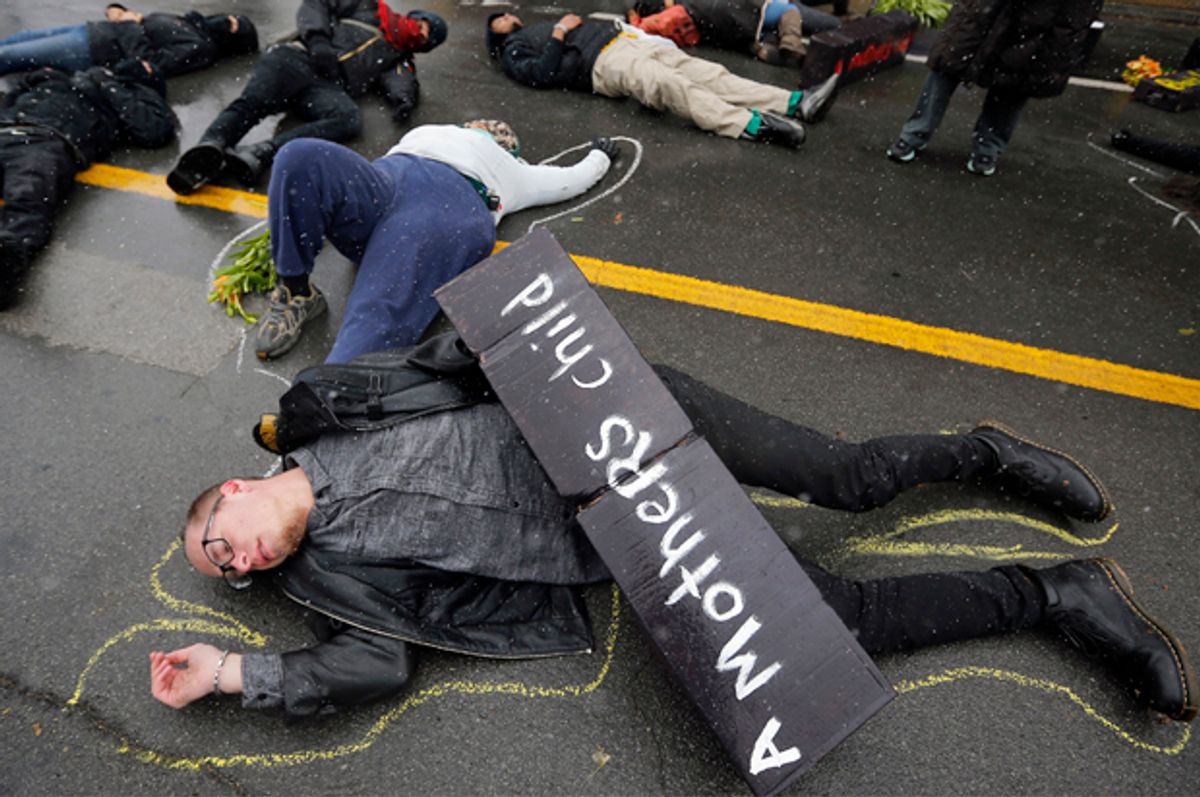 Demonstrators lie on the ground during a protest marking the 100th day since the shooting death of Michael Brown in St. Louis, Missouri November 16, 2014.            (Reuters/Jim Young)