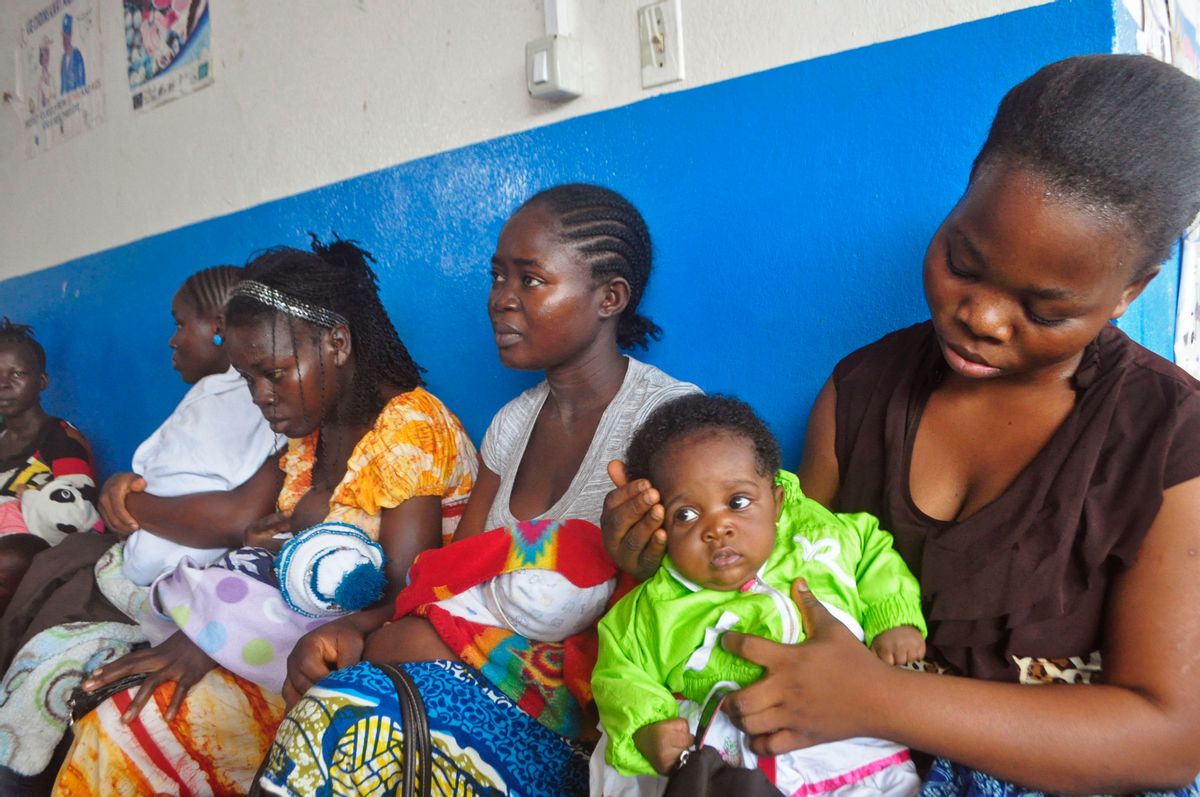 In this photo taken on Monday, Nov. 3, 2014,  mothers wait inline for their children to be vaccinated by heath workers at the Pipeline Community Health Center, situated on the outskirts of  Monrovia, Liberia.  The Ebola outbreak has spawned a silent killer, experts say: hidden cases of malaria, pneumonia, typhoid and the like that are going untreated because people in the countries hardest hit by Ebola either cannot find an open clinic or are too afraid to go to one. (AP/Abbas Dulleh)