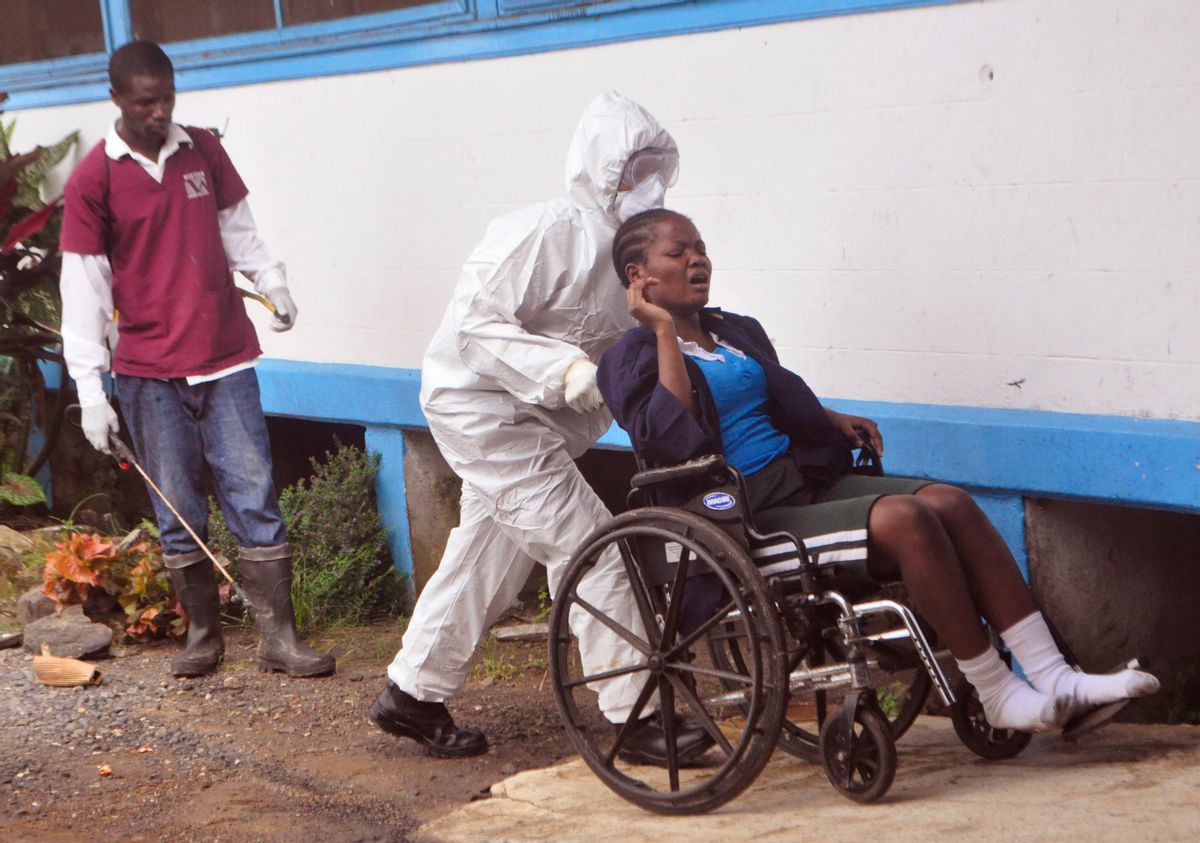 In this photo taken on Saturday, Nov. 1, 2014,  a woman prisoner suspected of suffering from the Ebola virus, from Tubmanburg central prison, is pushed in a wheelchair towards a medical vehicle,  to be taken to an Ebola treatment center in Monrovia, Liberia. The Ebola outbreak has spawned a silent killer, experts say: hidden cases of malaria, pneumonia, typhoid and the like that are going untreated because people in the countries hardest hit by Ebola either cannot find an open clinic or are too afraid to go to one. (AP Photo/ Abbas Dulleh)  (AP)