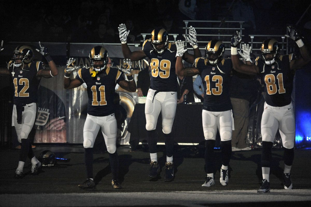 Members of the St. Louis Rams raise their arms as they walk onto the field during introductions before an NFL football game against the Oakland Raiders, Sunday, Nov. 30, 2014, in St. Louis. (AP Photo/L.G. Patterson)    (AP)