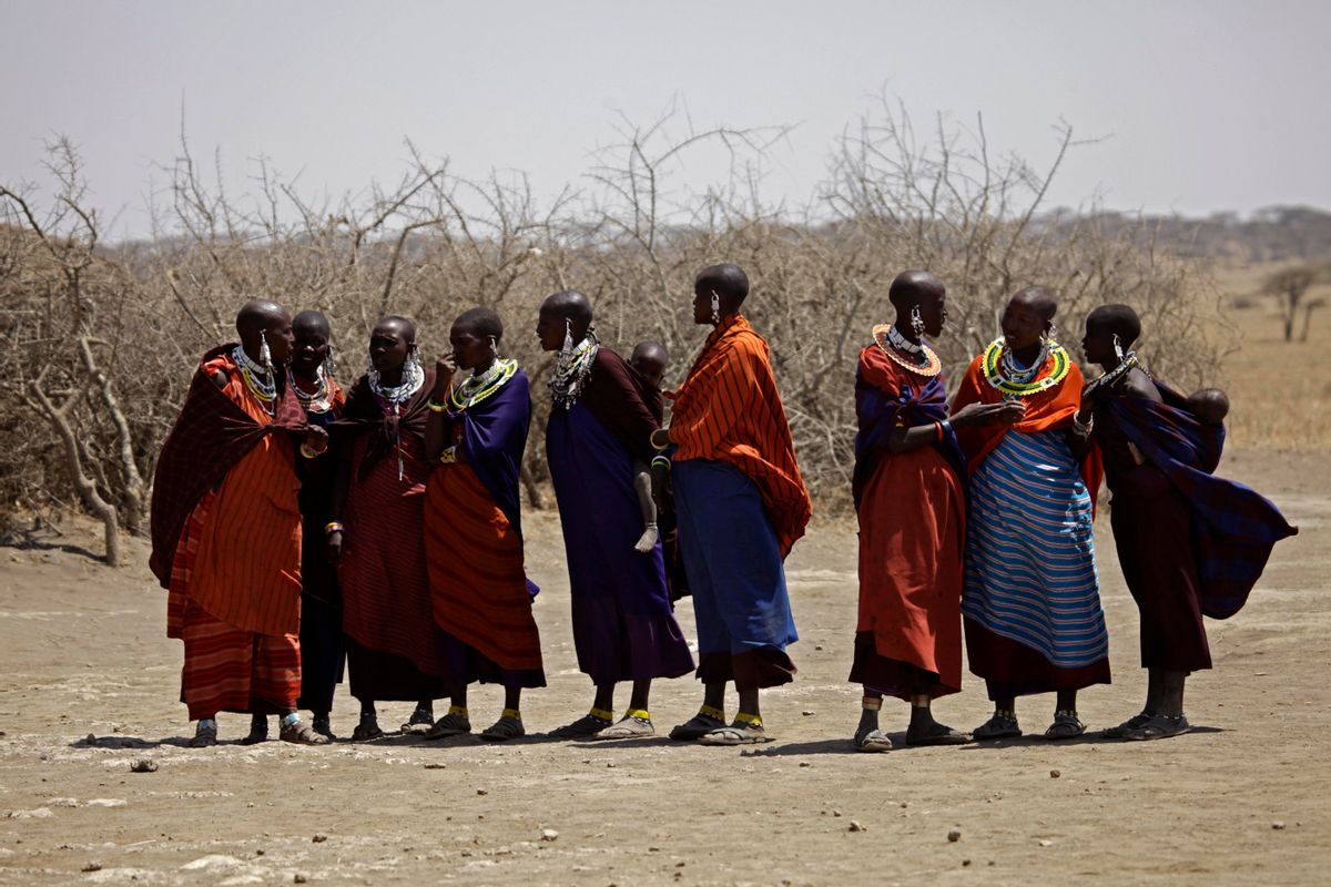 FILE - In this Monday, Aug. 12, 2013 file photo, Maasai tribeswomen gather at a village on the outskirts of the Serengeti, in northern Tanzania.  (AP/Nariman El-Mofty)
