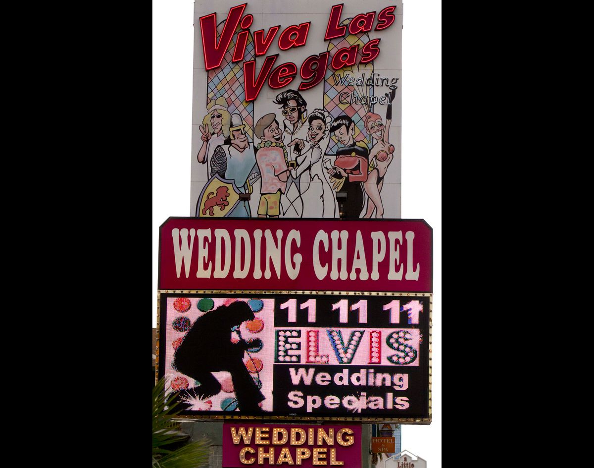 FILE - The Viva Las Vegas Wedding Chapel marquee advertises wedding specials on in this Nov. 11, 2011 file photo taken in Las Vegas. The Viva Las Vegas wedding chapel plans to marry 120 couples Saturday Dec. 13, 2014 starting with Egyptian-themed nuptials followed by weddings with a touch of Tom Jones, gangsters, Liberace and, of course, Elvis, said general manager Brian Mills. (AP Photo/Julie Jacobson, File) (AP)