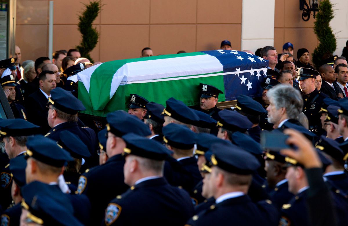 ADDS FLAG IS THAT OF THE NYPD - The body of New York City police officer Rafael Ramos is brought from Christ Tabernacle Church draped in an NYPD flag after his funeral in the Glendale section of Queens, where he was a church member, Saturday, Dec. 27, 2014, in New York. Ramos and his partner, officer Wenjian Liu, were killed Dec. 20 as they sat in their patrol car on a Brooklyn street. The shooter, Ismaaiyl Brinsley, later killed himself.  (AP Photo/Craig Ruttle) (AP)