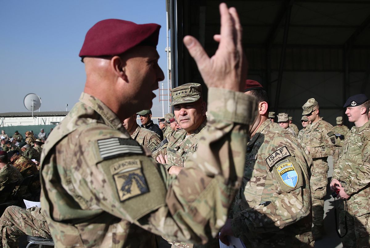 Commander of International Security Assistance Force, General John F. Campbell, center, takes part in a flag-lowering ceremony in Kabul International Airport in Kabul, Afghanistan, Monday, Dec. 8, 2014. The U.S. and NATO ceremonially ended their combat mission in Afghanistan on Monday, 13 years after the Sept. 11 terror attacks sparked their invasion of the country to topple the Taliban-led government. (AP Photo/Massoud Hossaini) (AP)