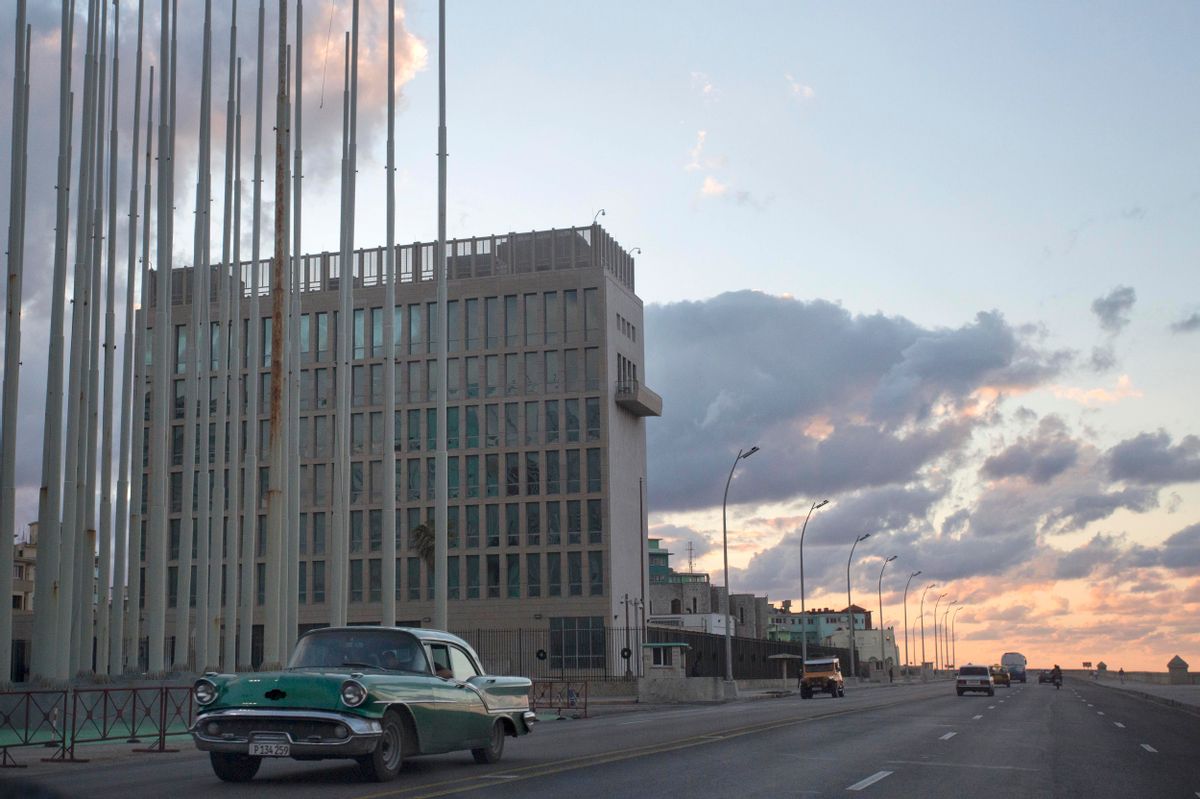An American classic car passes next to the building of the US Interests Section in Havana, Cuba, Wednesday, Dec. 17, 2014.  President Barack Obama announced the re-establishment of diplomatic relations as well as an easing in economic and travel restrictions on Cuba Wednesday, declaring an end to America's "outdated approach" to the island in a historic shift that aims to bring an end to a half-century of Cold War enmity.(AP Photo/Desmond Boylan) (AP)