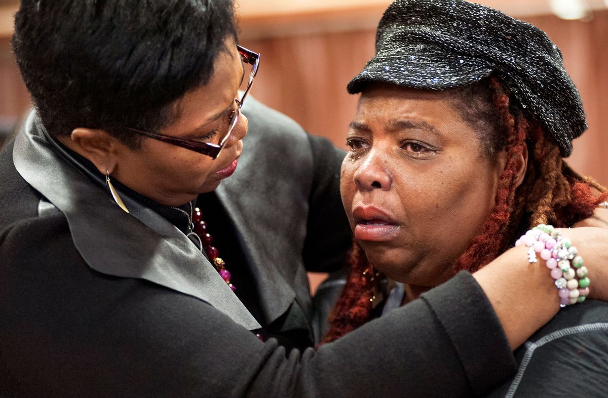 Dell Taylor, right, is comforted by the Rev.Traci Blackmon, a member of the Ferguson Commission appointed by Missouri Gov. Jay Nixon, during the opening meeting of the commission at the Ferguson Community Center in Ferguson, Mo. Monday, Dec. 1, 2014.  The 16-person panel was chosen by Missouri's governor to help find long-term solutions after the Ferguson police shooting of an unarmed man. (AP Photo/Sid Hastings) (AP)