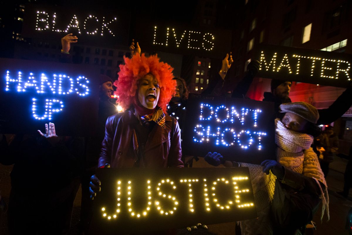 A demonstrator chants during a rally in downtown Manhattan in New York, Saturday, Dec. 13, 2014, during the Justice for All rally and march. In the past three weeks, grand juries have decided not to indict officers in the chokehold death of Eric Garner in New York and the fatal shooting of Michael Brown in Ferguson, Mo. The decisions have unleashed demonstrations and questions about police conduct and whether local prosecutors are the best choice for investigating police. (AP Photo/John Minchillo) (AP)