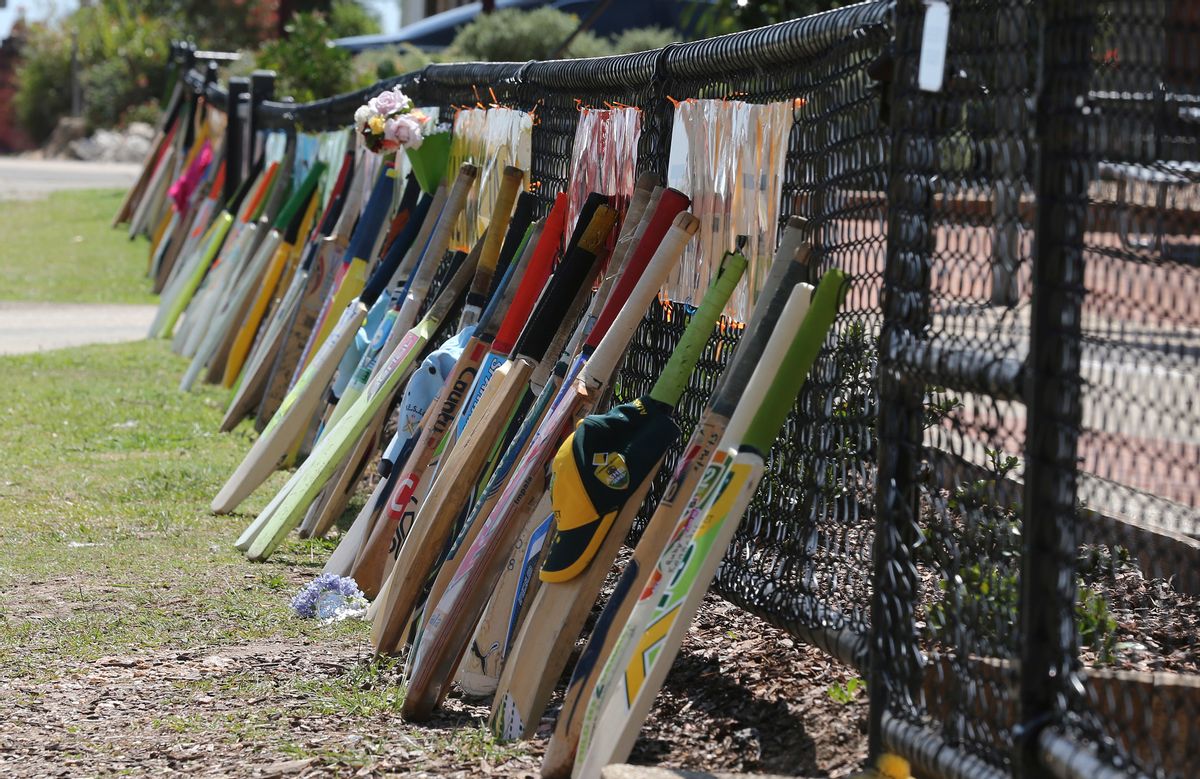 Cricket bat stand as tribute outside a primary school during the funeral of Australian cricketer Phil Hughes in Macksville, Australia, Wednesday, Dec. 3, 2014. Hughes, 25,  died last Thursday, two days after he was hit in the head during a domestic cricket match.(AP Photo/Rob Griffith) (AP)