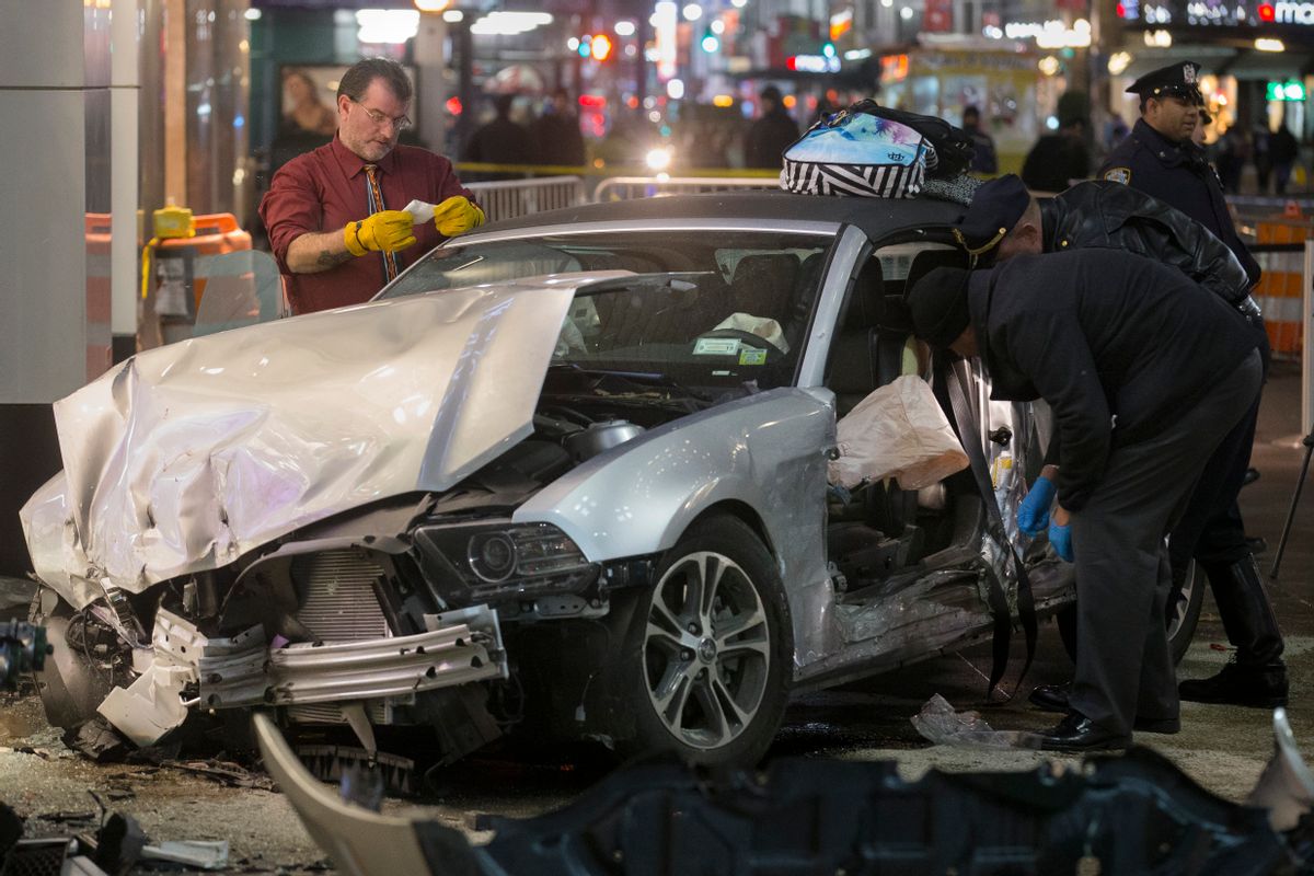 Police search a car at the scene of a vehicular accident on 34th Street, Thursday, Dec. 11, 2014, in New York. Six people were hurt when the car jumped a curb in midtown Manhattan and struck a group of people around 10 p.m. A fire department spokesman says the injured were taken to Bellevue hospital with serious but non-life threatening injuries. (AP Photo/John Minchillo) (AP)