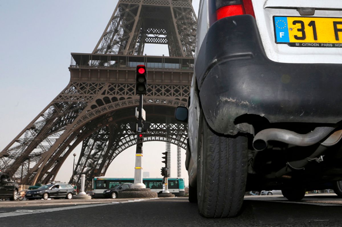 A car drives near the Eiffel tower in Paris, March 14, 2014.             (Reuters/Charles Platiau)