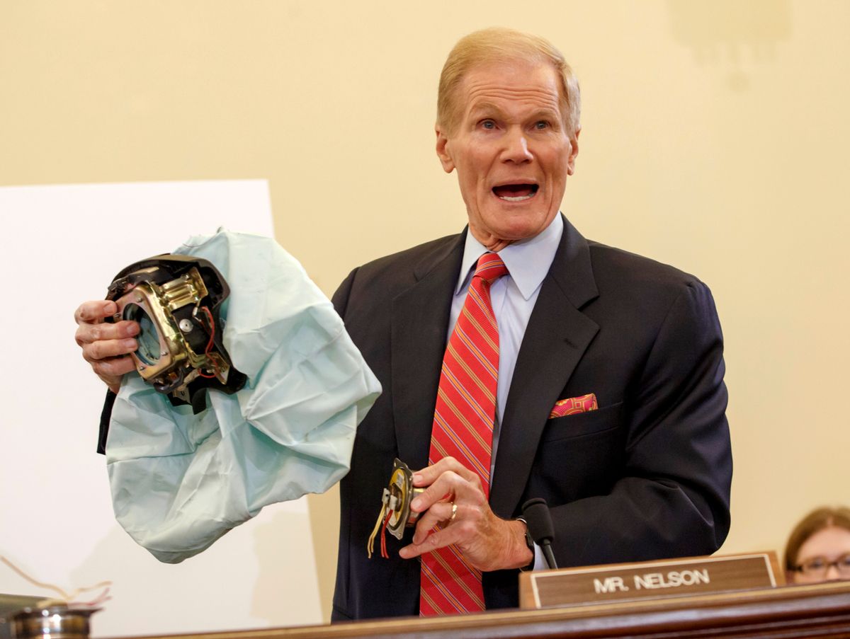 FILE - In this Nov. 20, 2014 file photo, U.S. Senate Commerce Committee member Sen. Bill Nelson, D-Fla. displays the parts and function of a defective airbag made by Takata of Japan that has been linked to multiple deaths and injuries in cars driven in the U.S., during the committee's hearing on Capitol Hill in Washington. Automakers issued more than 700 recalls in the U.S. alone this year, covering 55 million cars and trucks. (AP Photo/J. Scott Applewhite, File) (AP)