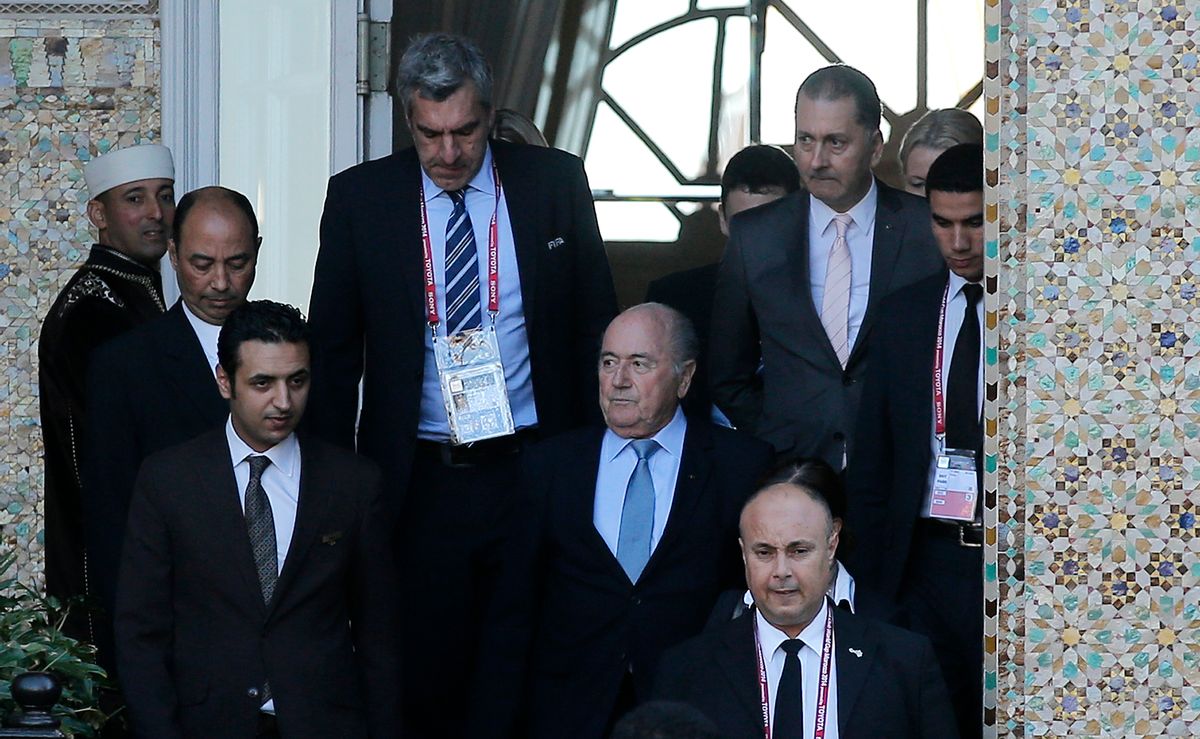 FIFA president Sepp Blatter, center, leaves a hotel to lead a meeting in Marrakech, Morocco, Thursday, Dec. 18, 2014. Amid another crisis at FIFA, Blatter will lead an executive committee meeting on Thursday with the sudden resignation of ethics prosecutor Michael Garcia now on the agenda. (AP Photo/Christophe Ena) (AP)