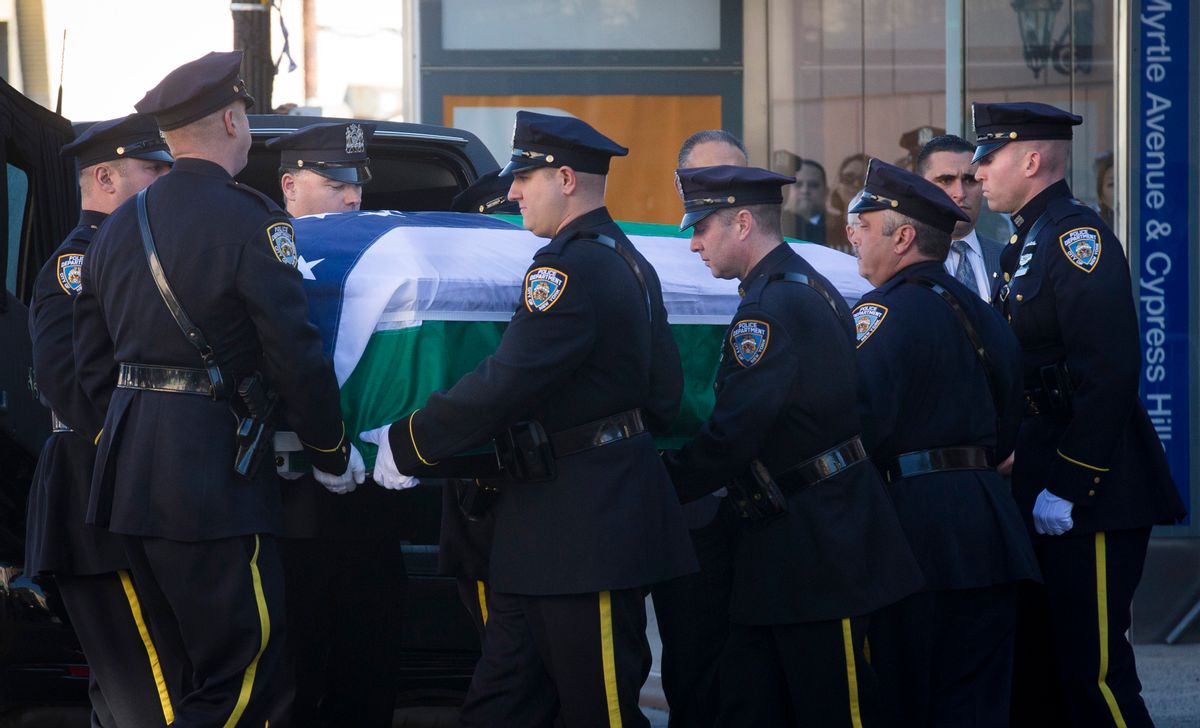 New York City police officers carry the casket of New York Police Department officer Rafael Ramos at his wake at Christ Tabernacle Church, in the Glendale section of Queens, where he was a member, Friday, Dec. 26, 2014, in New York.  Ramos was killed Dec. 20 along with his partner, Officer Wenjian Liu, as they sat in their patrol car in Brooklyn. The shooter, Ismaaiyl Brinsley, later killed himself. (AP Photo/John Minchillo) (AP)