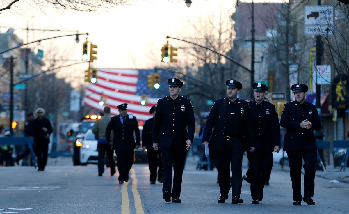 New York City police officers walk toward Christ Tabernacle Church before funeral services for officer Rafael Ramos at in the Glendale section of Queens, Saturday, Dec. 27, 2014, in New York. Ramos and his partner, officer Wenjian Liu, were killed Dec. 20 as they sat in their patrol car on a Brooklyn street. The shooter, Ismaaiyl Brinsley, later killed himself. (AP Photo/Julio Cortez) (AP)