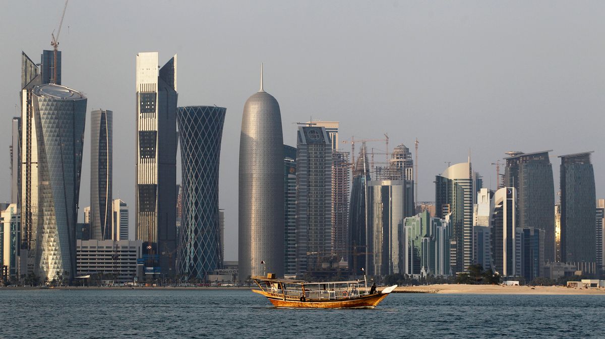 FILE - In this Thursday Jan. 6, 2011 file photo, a traditional dhow floats in the Corniche Bay area with tall buildings of the financial district in the background. The 2022 World Cup in Qatar, the wealthy oil- and gas-producing Gulf nation with giant look-at-me ambitions that belie its small size, is shaping up as a unique experience. (AP Photo/Saurabh Das, File) (AP Photo/Saurabh Das, File)