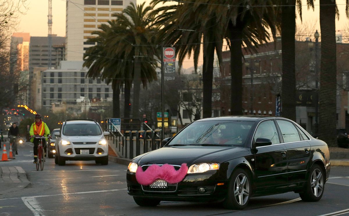 FILE - In this Jan. 17, 2013 file photo, a Lyft car drives crosses Market Street in San Francisco.  (AP Photo/Jeff Chiu, File)