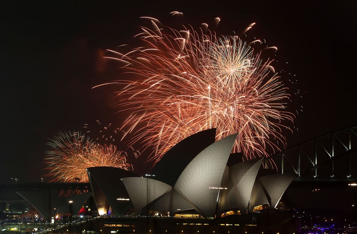 Fireworks explode over the Opera House and the Harbour Bridge during pre-New Years Eve  celebrations in Sydney, Australia, Wednesday, Dec. 31, 2014. Thousands of people crammed into Lady Macquaries Chair look-out to see the new year in and watch the annual fireworks show. (AP Photo/Rob Griffith) (Rob Griffith)