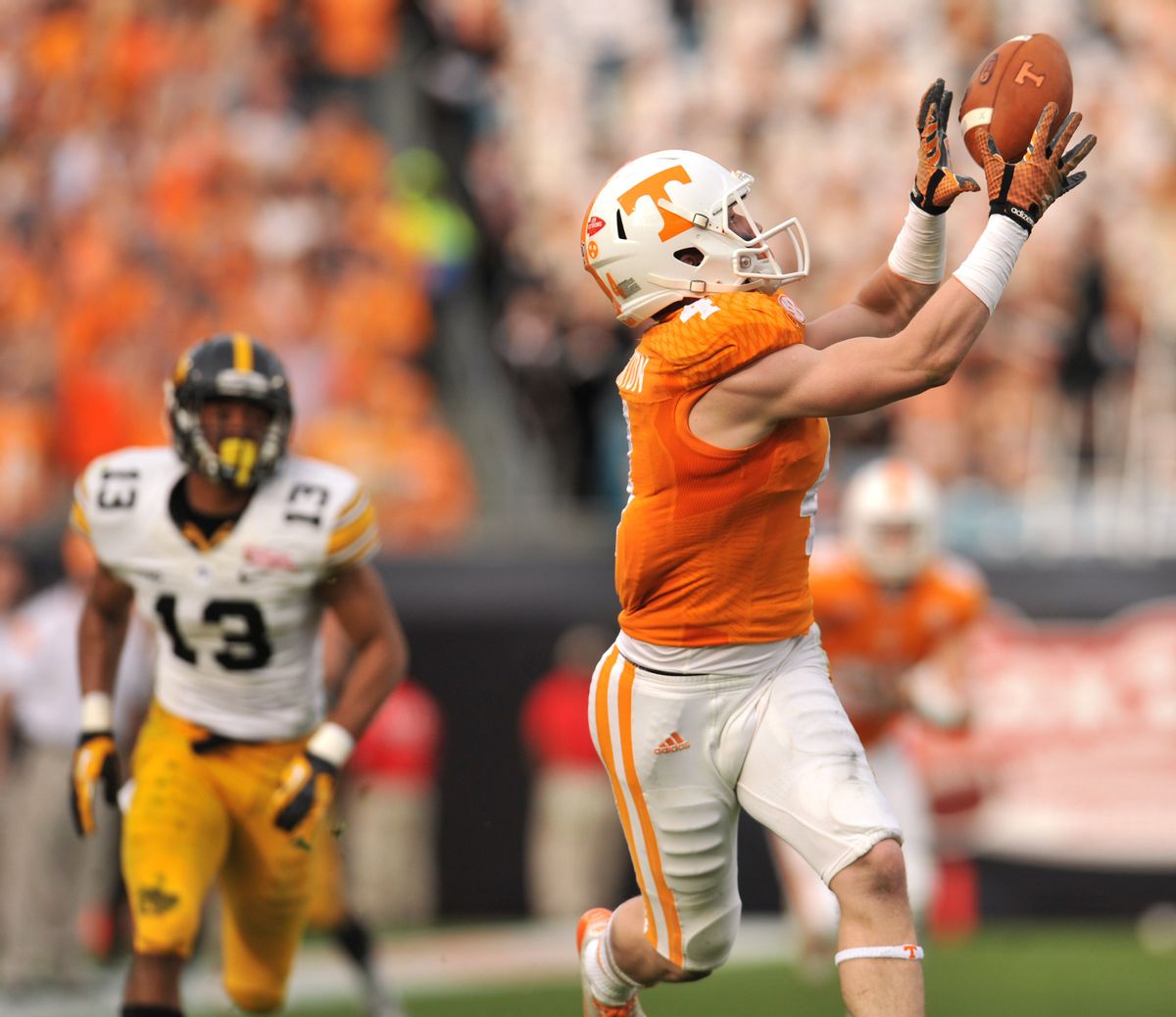 Tennessee's Vic Wharton pulls in a long pass for a touchdown during the first half of the TaxSlayer Bowl NCAA college football game against Iowa, Friday, Jan. 2, 2015, in Jacksonville, Fla. (AP Photo/The Florida Times-Union, Bob Self) (AP)
