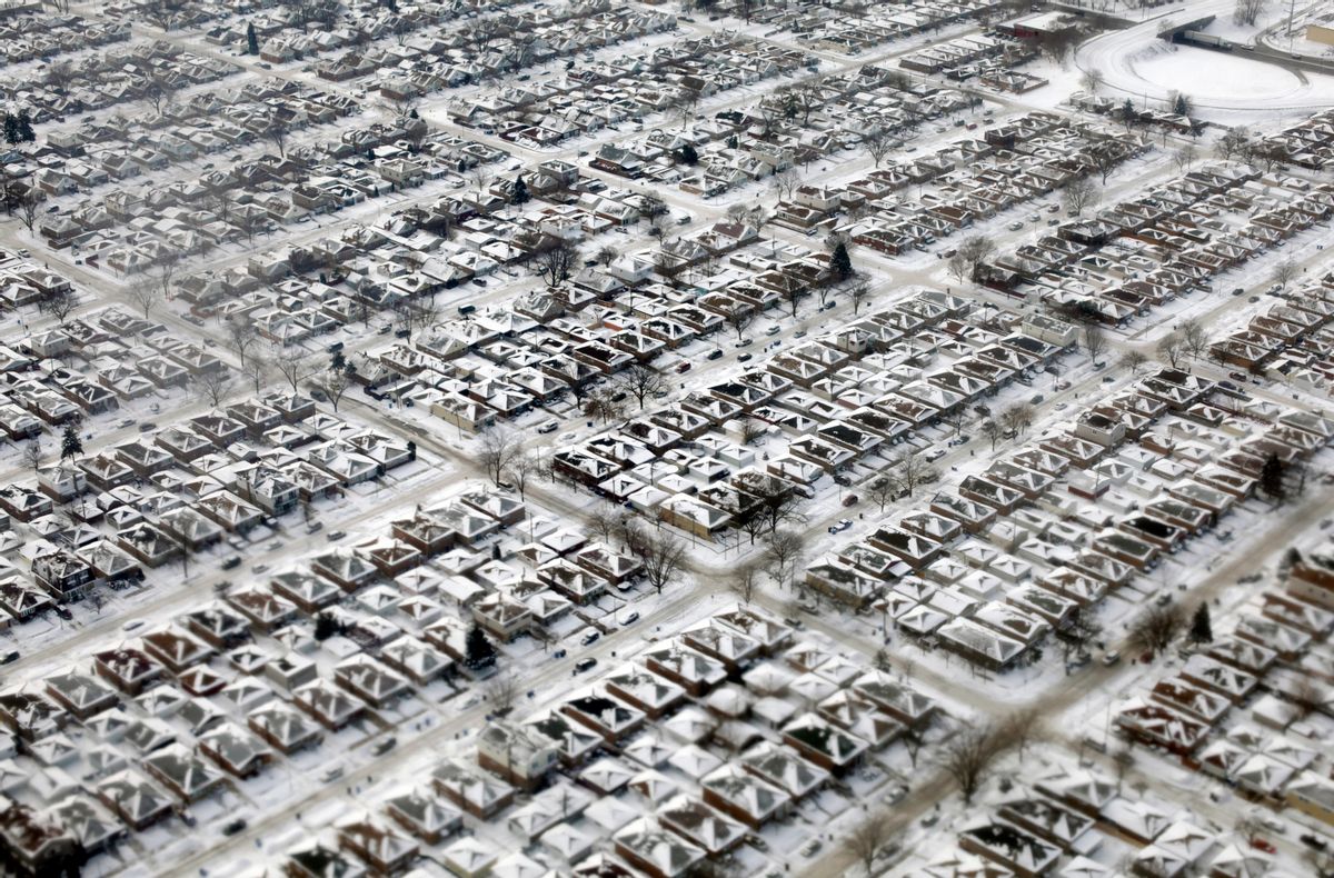 FILE- This Jan. 8, 2014, file photo shows homes covered in snow and ice in Chicago. (AP Photo/Kiichiro Sato, File) (AP)