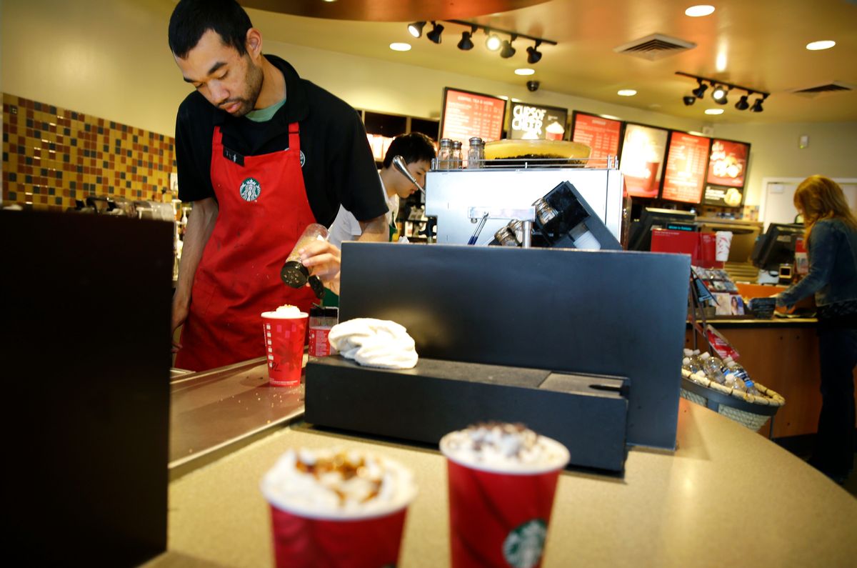 In this Nov. 24, 2014 photo, barista Jay Rapp prepares a Chestnut Praline Latte at a Starbucks store in Seattle. (AP Photo/Ted S. Warren)  (AP)