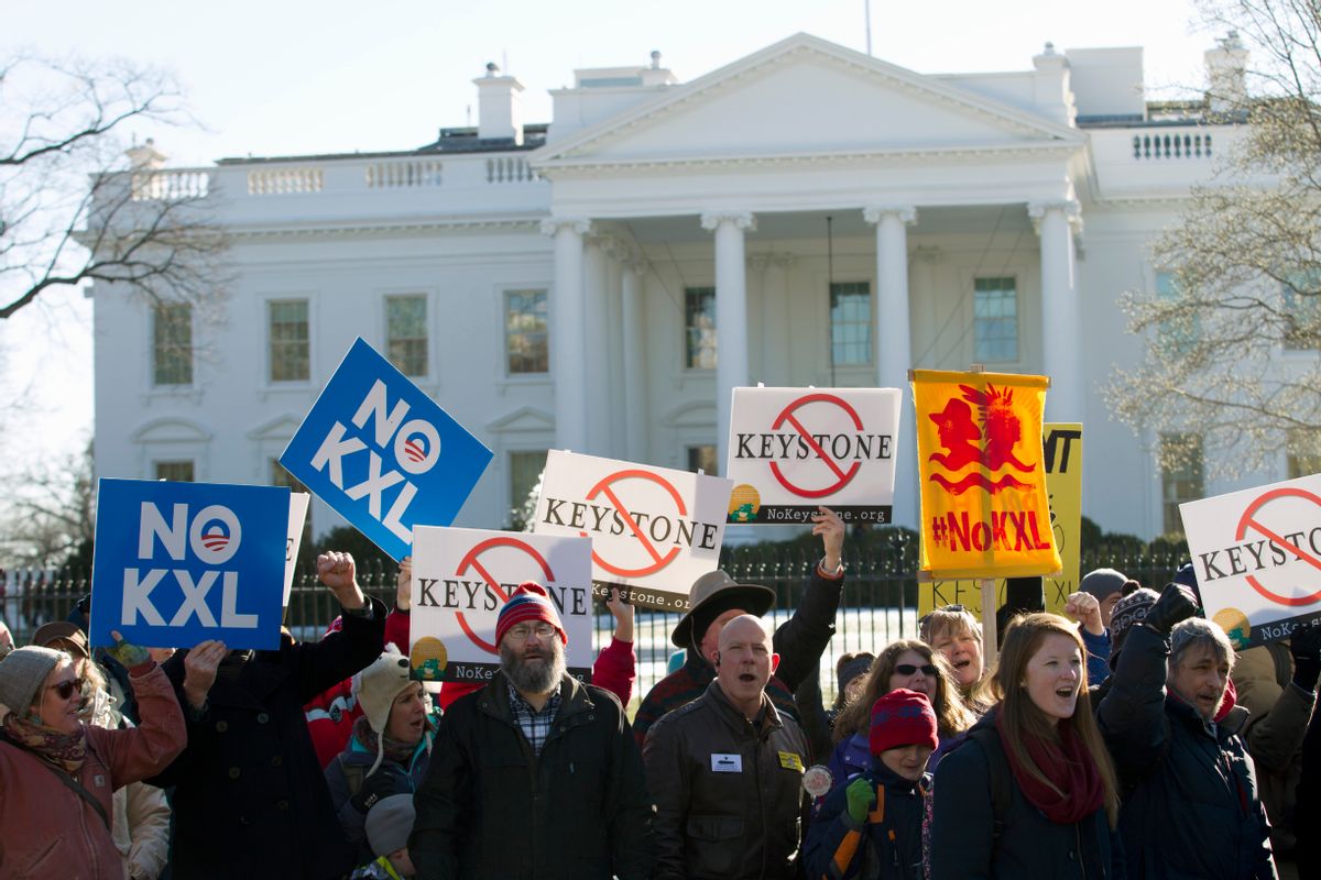 FILE - In this Jan. 10, 2015 file photo, demonstrators stand in front of the White House in Washington, during a rally in support of President Barack Obama's pledge to veto any legislation approving the Keystone XL pipeline. Supporters of the Keystone XL pipeline say the privately-funded, $8 billion project is a critically needed piece of infrastructure that will create thousands of jobs and make the U.S. dependent on oil from friends, rather than foes. Critics claim it will be disastrous for the pollution blamed for global warming and put communities along its 1,179-mile route at risk for an environmentally-damaging spill, all for oil and products that will be exported anyway. (AP Photo/Jose Luis Magana, File)   (AP)