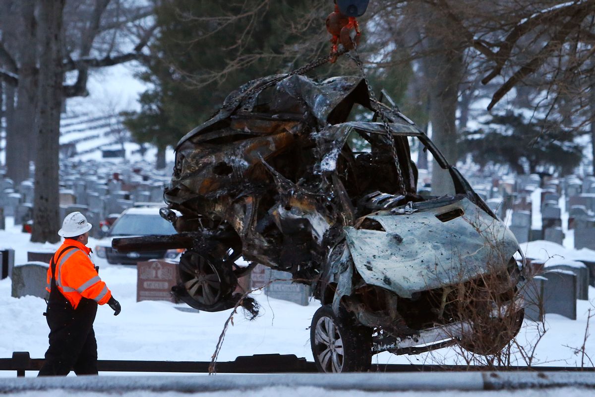 Emergency personnel work to remove the wreckage of a deadly SUV and commuter train accident in Valhalla, N.Y., Wednesday, Feb. 4, 2015. A packed Metro-North Railroad train slammed into a SUV on the tracks and erupted into flames Tuesday night, killing some and injuring others, sending hundreds of passengers scrambling for safety, authorities said. (AP Photo/Jason DeCrow) (AP)