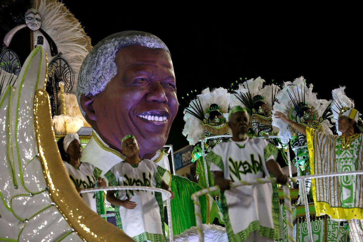 Performers from the Imperatriz Leopoldinense samba school parade on a float with an sculpture in the likeness of Nelson Mandela during carnival celebrations at the Sambadrome in Rio de Janeiro, Brazil, Tuesday, Feb. 17, 2015. (AP Photo/Silvia Izquierdo) (AP)