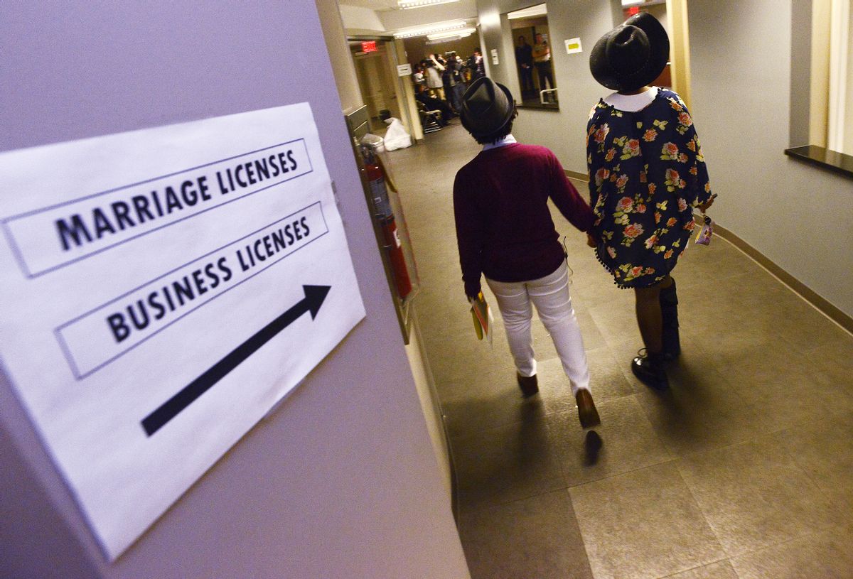 Shante Wolfe, left, and Tori Sisson walk to get their marriage license at the Montgomery County Probate Office in Montgomery, Ala. on Monday, Feb. 9, 2015.  (AP/Montgomery Advertiser, Mickey Welsh)