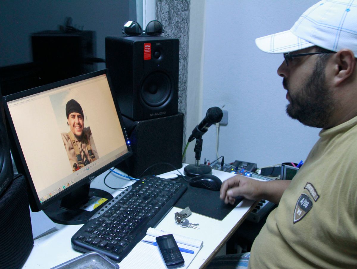 In this Dec. 4, 2014 photo, Mehdi "DJ Costa" Akkari, a Tunisian rapper, looks at an image of his brother Youssef, who fought with extremists in Syria and was killed by a U.S. airstrike, in Tunis, Tunisia. While foreigners from across the world have joined the Islamic State militant group, some arrive in Iraq or Syria only to find day-to-day life much more austere and violent than they had expected. (AP Photo/Paul Schemm) (AP)