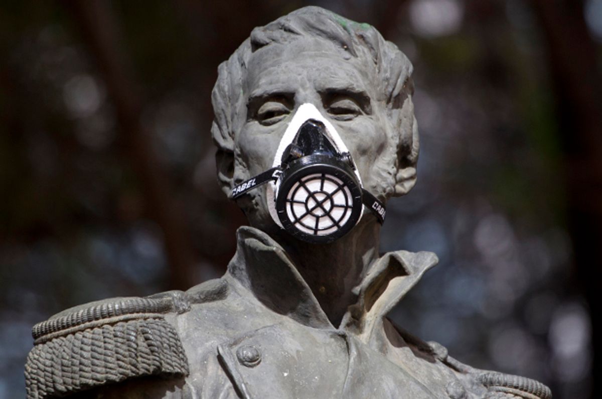 A gas mask covers the mouth on the statue of independence hero Leonardo Bravo in Mexico City, Feb. 28, 2012.      (AP/Eduardo Verdugo)