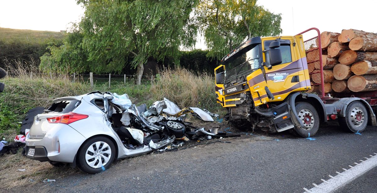 A small passenger car and a logging truck as seen after they collided head-on near Tokoroa, New Zealand, Tuesday Feb.  2015. Authorities said, U.S. citizens  Warren Lee, 53, and his wife Aesoon Lee, 52 and the couple's 20-year-old daughter, Julia Lee, were killed and their son critically injured when their car crashed into a logging truck.(AP Photo/NZ Herald/John van de Ven)**Australia Out New Zealand Out** (John Van De Ven)