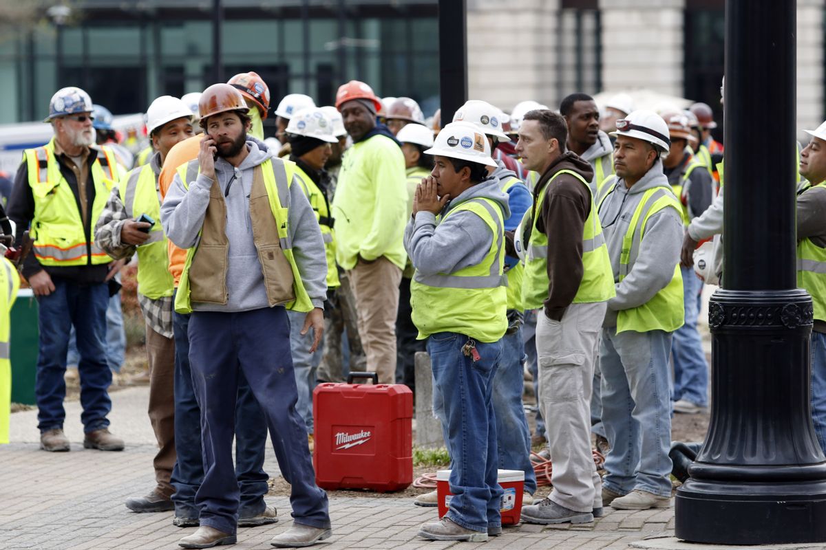 Construction workers gather outside the scene where a section of scaffolding collapsed at a high-rise construction project, killing three people and sending another to a hospital, Monday, March 23, 2015, in downtown Raleigh, N.C. (AP Photo/The News &amp; Observer, Harry Lynch) (AP)