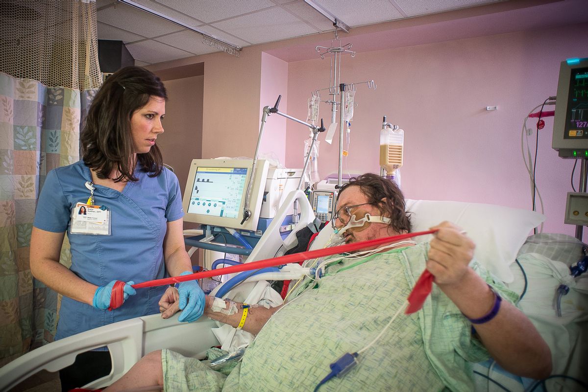 In this photo provided by the Wake Forest Baptist Medical Center, taken March 11, 2015 in the intensive care unit at Wake Forest Baptist Medical Center, physical therapist Katie Kellner helps patient Terry Culler do some exercises and briefly stand despite being hooked to a ventilator. There's increasing evidence that mild exercise may have its place even for the sickest ICU patients, and new animal research suggests it may target both muscles and lungs. (AP Photo/Warren Cameron Dennis III, Wake Forest Baptist Medical Center) (AP)
