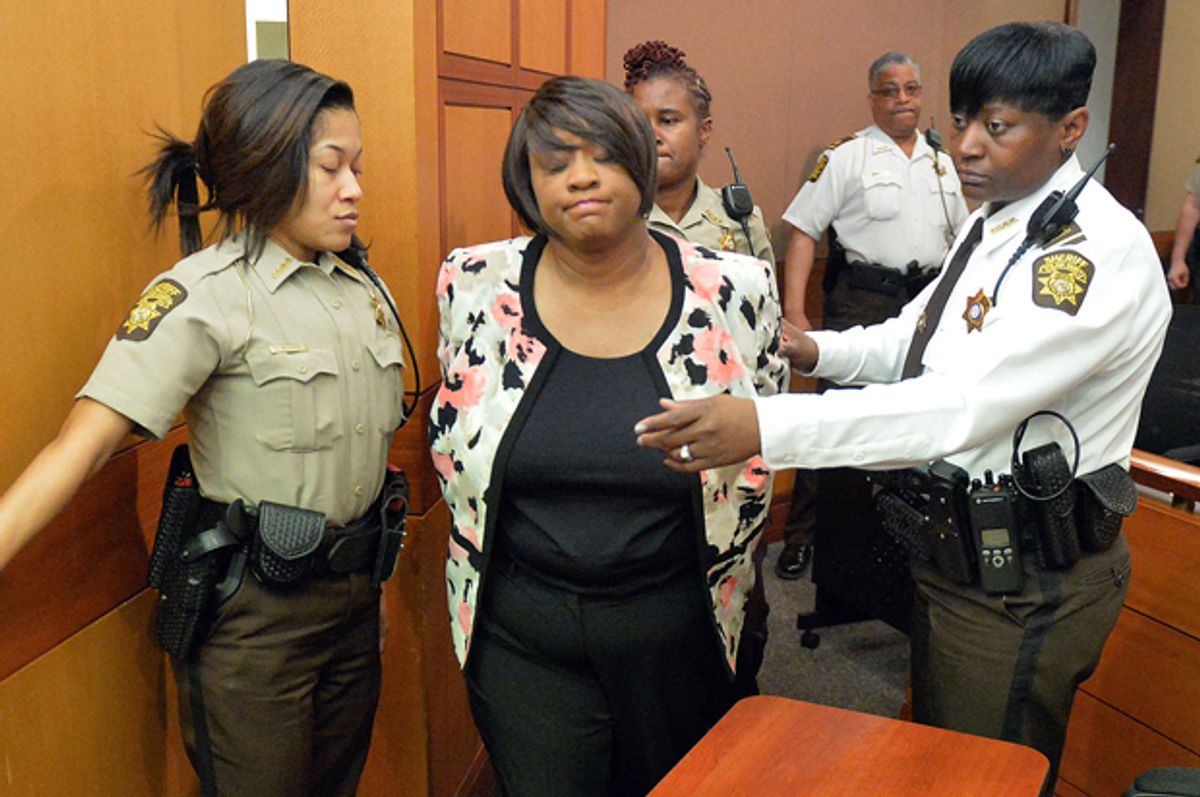 Former Atlanta Public Schools school research team director Tamara Cotman, center, is led to a holding cell after a jury found her guilty in the Atlanta Public Schools test-cheating trial, Wednesday, April 1, 2015, in Atlanta.       (AP/Kent D. Johnson)