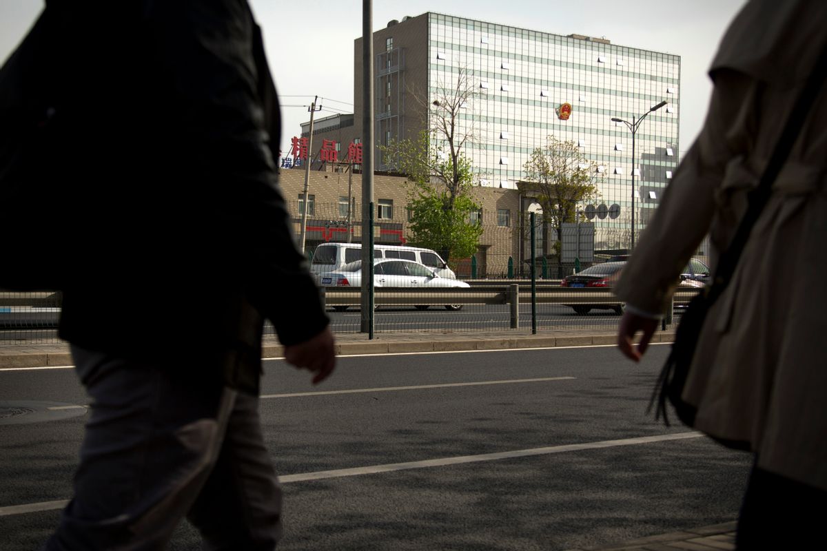People walk near the Beijing No. 3 Intermediate Court in Beijing, Friday, April 17, 2015. Veteran Chinese journalist Gao Yu was sentenced to seven years in prison Friday for leaking a document detailing the Communist Party leadership's resolve to aggressively target civil society and press freedom as a threat to its monopoly on power. (AP Photo/Mark Schiefelbein) (Mark Schiefelbein)