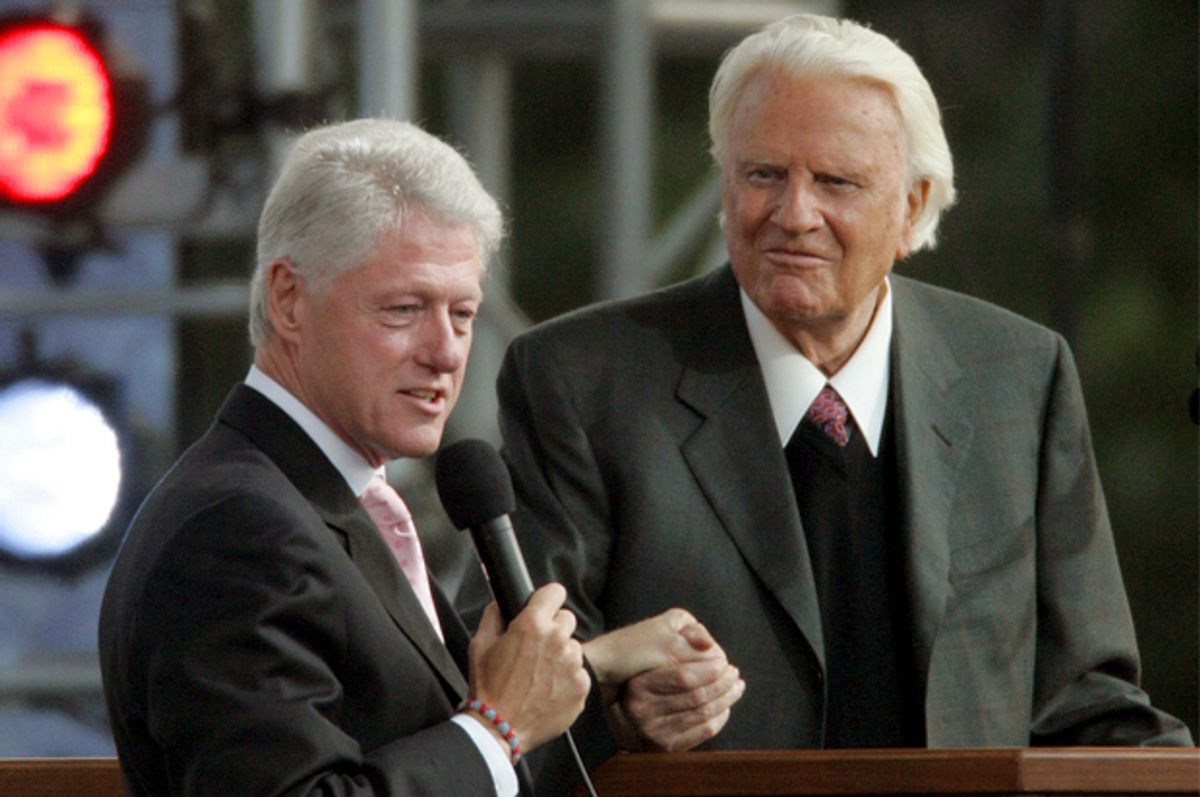 Former president Bill Clinton, left, speaks alongside the Rev. Billy Graham on the second night of the Greater New York Billy Graham Crusade Saturday, June 25, 2005 at Flushing Meadows Corona Park in New York borough of Queens. (AP Photo/Frank Franklin II)       (Frank Franklin Ii)