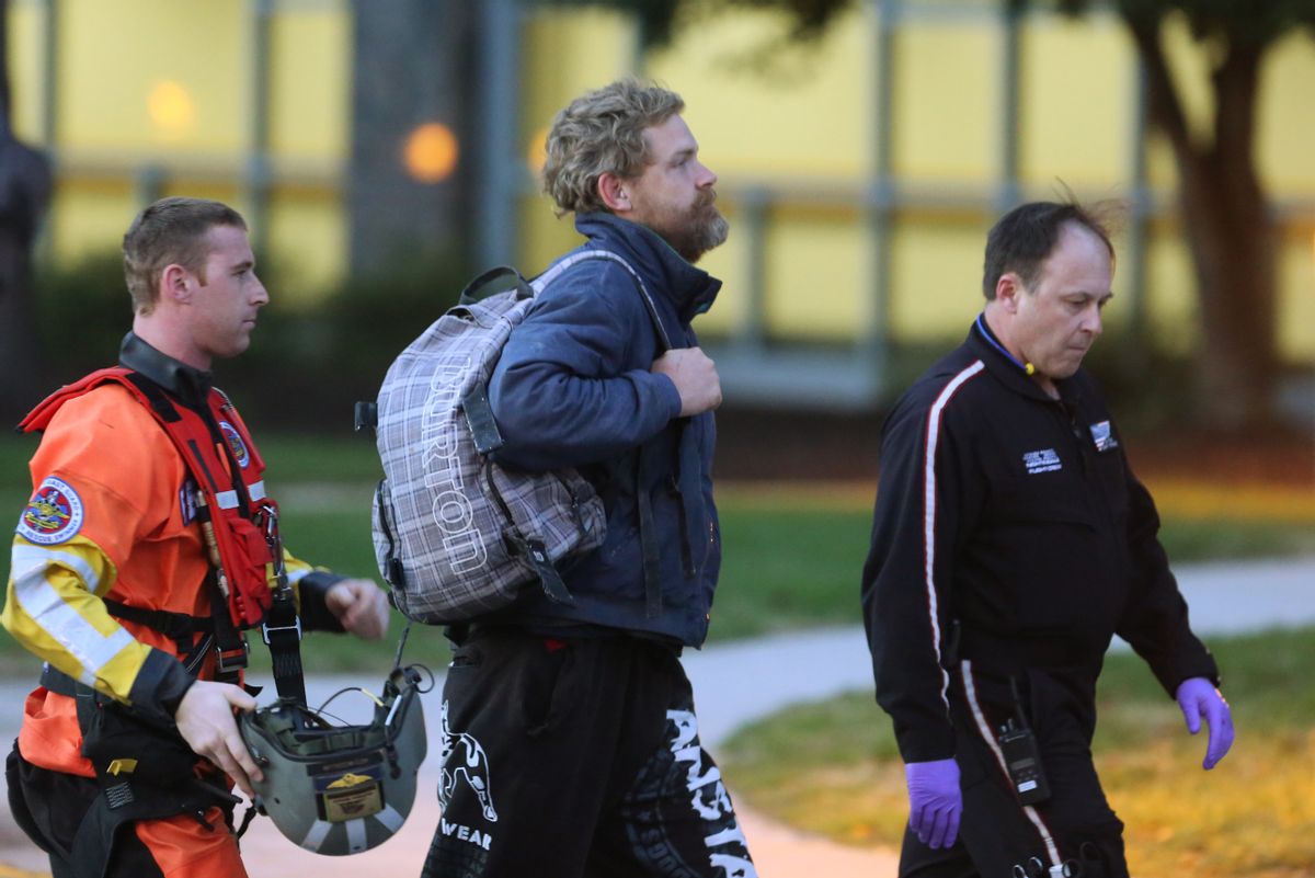 Louis Jordan, center, walks from the Coast Guard helicopter to the Sentara Norfolk General Hospital in Norfolk, Va., after being found off the North Carolina coast, Thursday, April 2, 2015. His family says he sailed out of a marina in Conway, S.C., on Jan. 23, and hadn't been heard from since. (AP Photo/The Virginian-Pilot, Steve Earley) (AP)