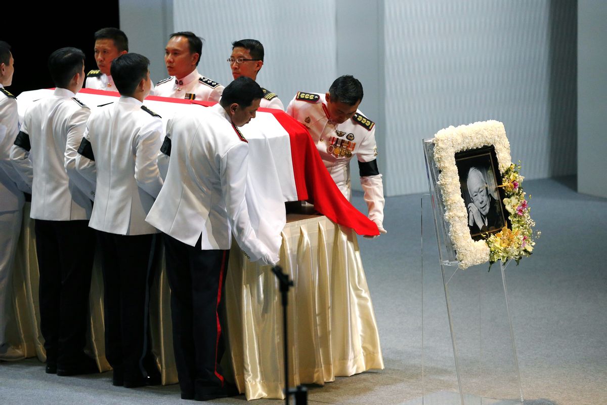 Pallbearers adjust the national flag of Singapore covering the coffin of the late Lee Kuan Yew during a state funeral held at the University Cultural Center, Sunday, March 29, 2015, in Singapore. During a week of national mourning that began Monday after Lee's death at age 91, some 450,000 people queued for hours for a glimpse of Lee's coffin at Parliament House. A million people visited tribute sites at community centers across the island and leaders and dignitaries from more than two dozen countries attended the state funeral. (AP Photo/Wong Maye-E) (Wong Maye-e)