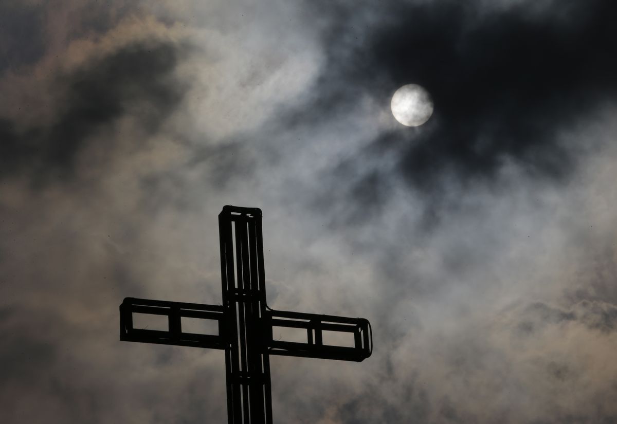 In this April 5, 2015, photo, dark clouds partially cover the sun above a church on Easter Sunday, north of Manila, Philippines. Tropical storm Maysak weakened before hitting the Philippines' northeastern coast Sunday, driving away thousands of Lenten holiday vacationers and tourists. (AP Photo/Aaron Favila, File) (AP)
