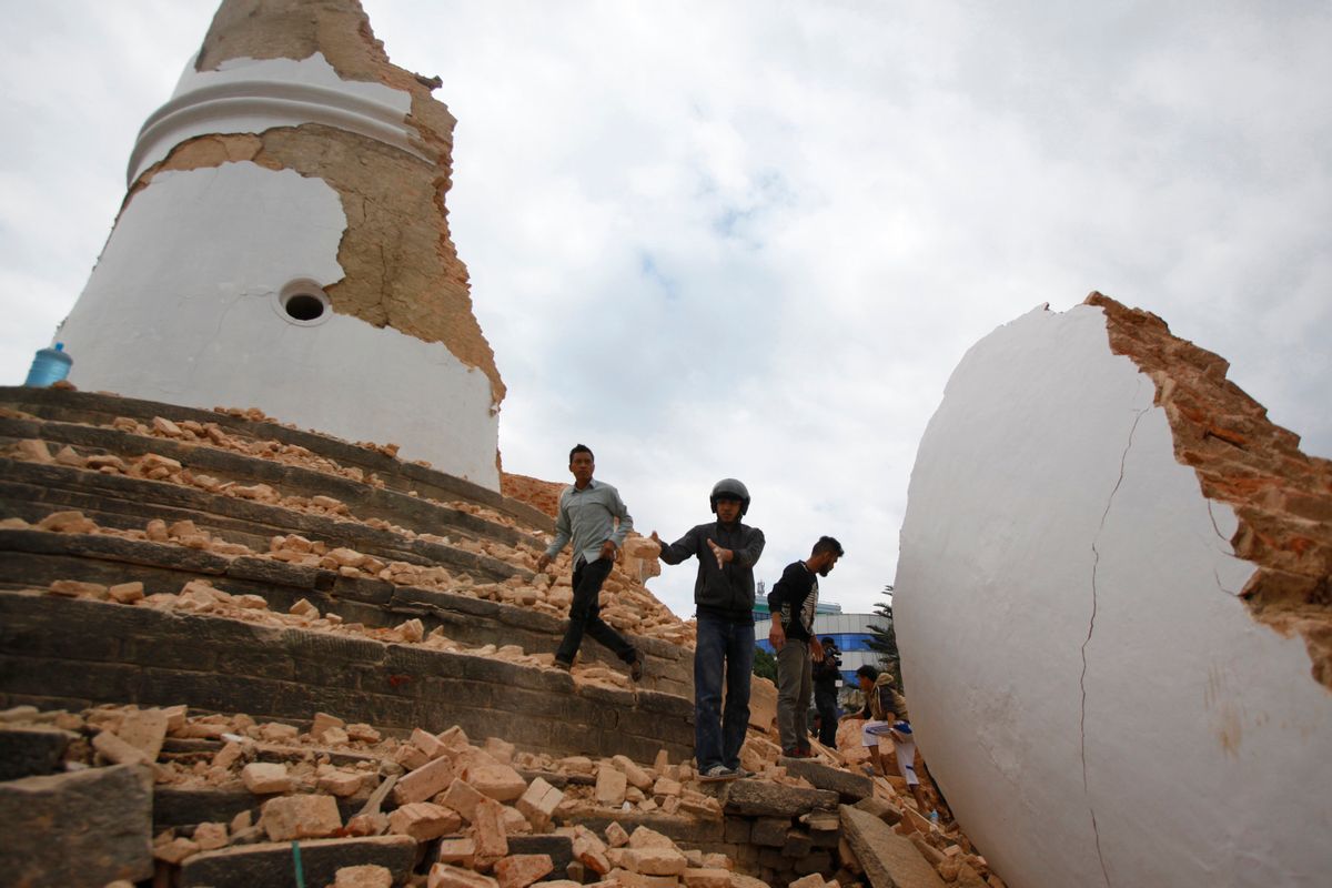 In this Saturday, April 25, 2015, file photo, volunteers work to remove debris at the historic Dharahara tower after an earthquake in Kathmandu, Nepal. A strong magnitude-7.8 earthquake shook Nepal's capital and the densely populated Kathmandu Valley before noon Saturday, causing extensive damage with toppled walls and collapsed buildings, officials said. (AP Photo/ Niranjan Shrestha, File) (Niranjan Shrestha)
